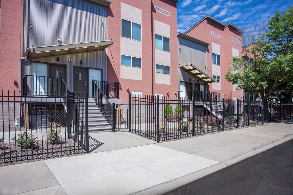 History of East Cleveland: Circle East Townhomes are built in 2010 | Sidewalk view of a row of modern townhomes on a sunny day
